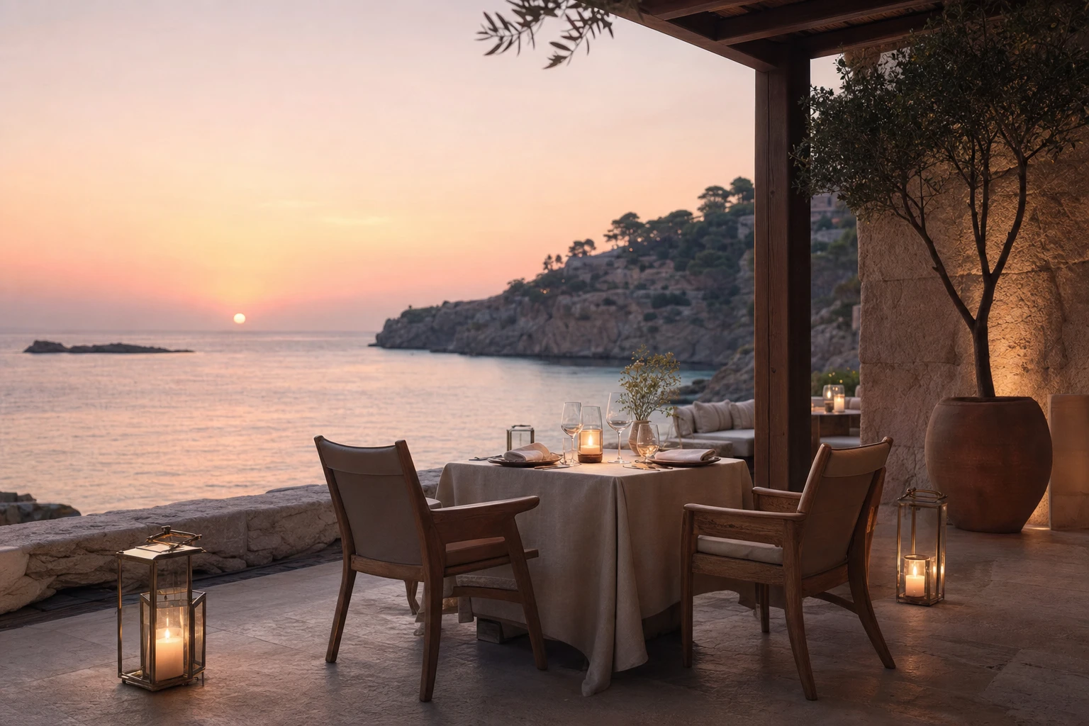 A candlelit table at the water's edge at sunset